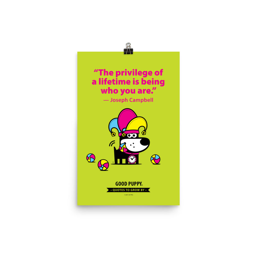 The image features a light green background with pink text that reads, "The privilege of a lifetime is being who you are." - Joseph Campbell. Below the quote, there is an illustration of a black dog with a clock around its neck, wearing a colorful jester hat, and surrounded by colorful balls. At the bottom, it says "GOOD PUPPY" with a banner stating "Quotes to Grow By."