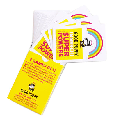 The image displays an open box of "Good Puppy Innerchi Super Powers" cards. The box, bright yellow with a rainbow and puppy logo, highlights that it includes three games in one: a real-life experience game, a memory game, and a challenge game. The cards, partially visible, are designed to help children aged 3-9 recognize, understand, and verbalize emotions while developing a healthy moral code.