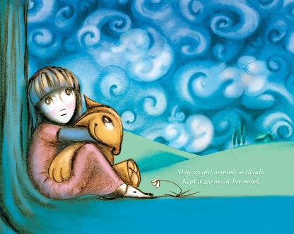 The image shows May sitting under a tree, hugging her stuffed animal, Flynn, while looking at the sky filled with swirling clouds. The background features green hills and a small house. The text reads, "May sought animals in clouds. Kept a zoo inside her mind."